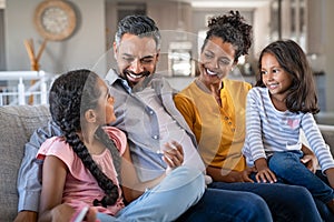 Happy joyful mixed race family having fun together photo