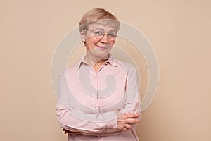 Happy joyful senior lady looking at camera and smiling