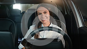 Happy joyful toothy smiling Caucasian woman smile looking at camera sit inside new rental luxury modern car girl female