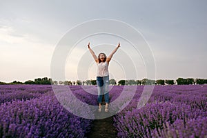 Happy and joyful woman enjoys happiness in a lavender field