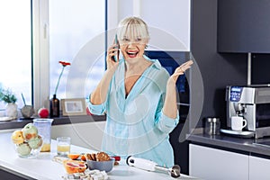 Happy joyful woman having a phone conversation