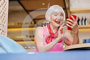 Happy joyful woman using her gadget