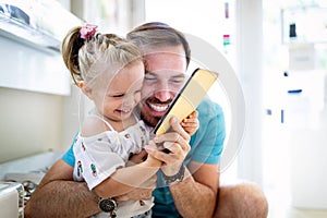 Happy joyful young father with his little daughter. Father and little kid having fun