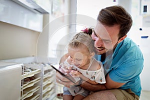 Happy joyful young father with his little daughter. Father and little kid having fun