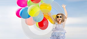 Happy jumping girl with colorful balloons