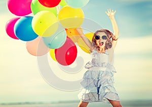 Happy jumping girl with colorful balloons