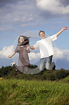 Happy jumping teenage couple