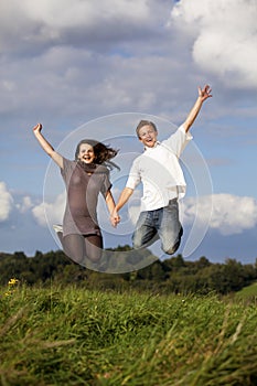 Happy jumping teenage couple