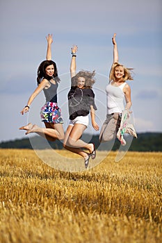 Happy jumping teenage girls