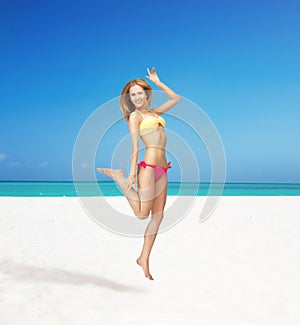 Happy jumping woman on the beach