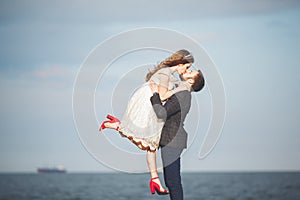 Happy just married young wedding couple celebrating and have fun at beautiful beach sunset