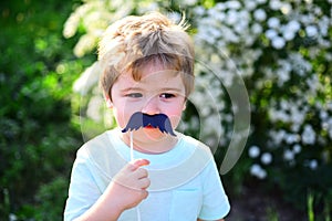 Happy kid in blooming nature. spring holiday. Sunny weather. Childhood happiness. Childrens day. Little boy child in