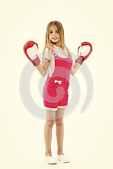 Happy kid in boxing gloves isolated on white. Little girl smile after boxing trainings. Punching. Childhood development