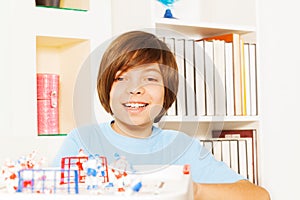 Happy kid boy playing ice hockey table board game