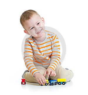 Happy kid boy playing with train toy isolated