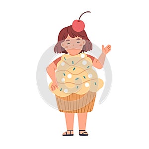 Happy kid disguised in funny carnival costume of sweet cupcake. Girl wearing dessert candy shaped clothes for Halloween
