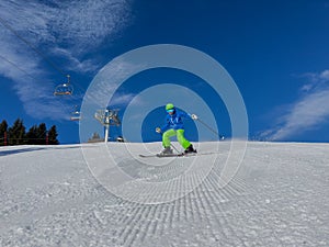 Happy kid in dynamic ski slope moment at alpine mountain resort