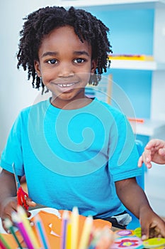 Happy kid enjoying arts and crafts painting