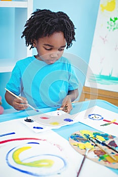 Happy kid enjoying arts and crafts painting