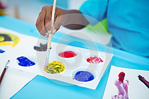 Happy kid enjoying arts and crafts painting