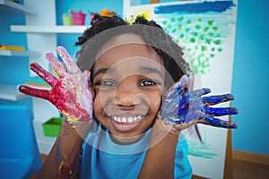 Happy kid enjoying arts and crafts painting photo
