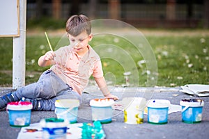 HAPPY KID ENJOYING ARTS WITH WATER COLOURS