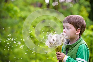 Happy kid enjoying sunny late summer and autumn day in nature on green grass.