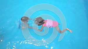 Happy kid family are funny swimming in swimming pool on summer holiday
