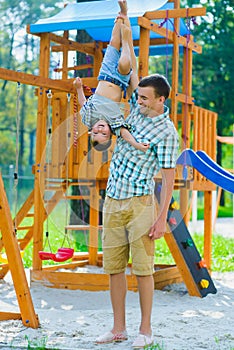 Happy kid and father having fun. Child with dad playing