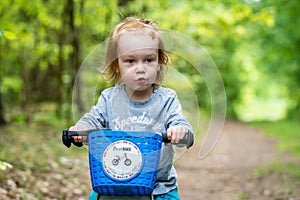happy kid in forest with balance bike