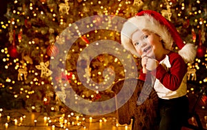 Happy Kid front of Christmas Free Lights, Happy Baby Boy in Night Domestic Xmas Room, Baby in Red Hat