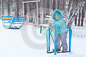 Happy kid girl child outdoors in winter playing