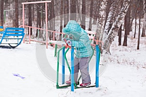 Happy kid girl child outdoors in winter playing and training