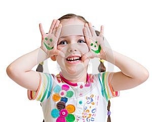 Happy kid girl showing painted hands with funny