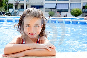 Happy kid girl smiling at swimming pool