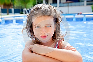 Happy kid girl smiling at swimming pool