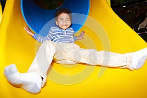Happy Kid Going Down Slide