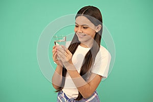 happy kid going to drink glass of water to stay hydrated and keep daily water balance, hydration.