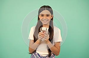 happy kid going to drink glass of water to stay hydrated and keep daily water balance, thirst.