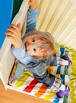 Happy kid hands on bed