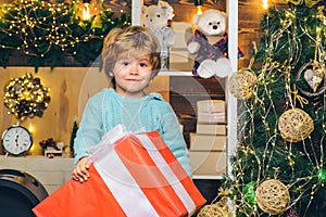 Happy kid having fun with big gift box. Christmas decorations. Wish you merry Christmas. Christmas kids. Models child