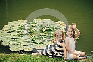 Happy kid having fun. Children happy smile on green lake landscape