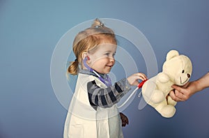 Happy kid having fun. Happy kid vet doctor examine toy pet with stethoscope