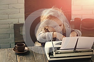 Happy kid having fun. small boy or businessman child with typewriter