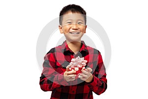 Happy kid holding christmas gift box with smile wearing red shirt