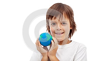 Happy kid holding earth globe made of clay