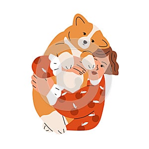 Happy kid holding, hugging cute chunky dog of corgi breed. Girl pet owner with canine animal in arms. Child and doggy