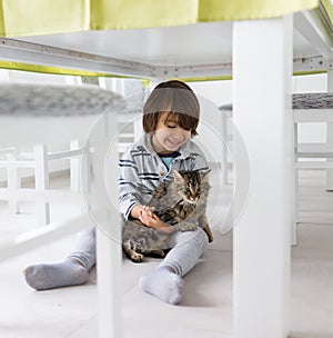 Happy kid at home with cat