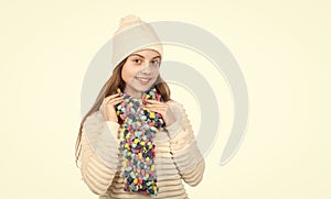 happy kid in knitted hat and scarf warm clothes isolated on white copy space, knitwear