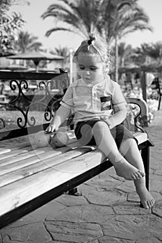 Happy kid or little boy barefoot with orange fruit